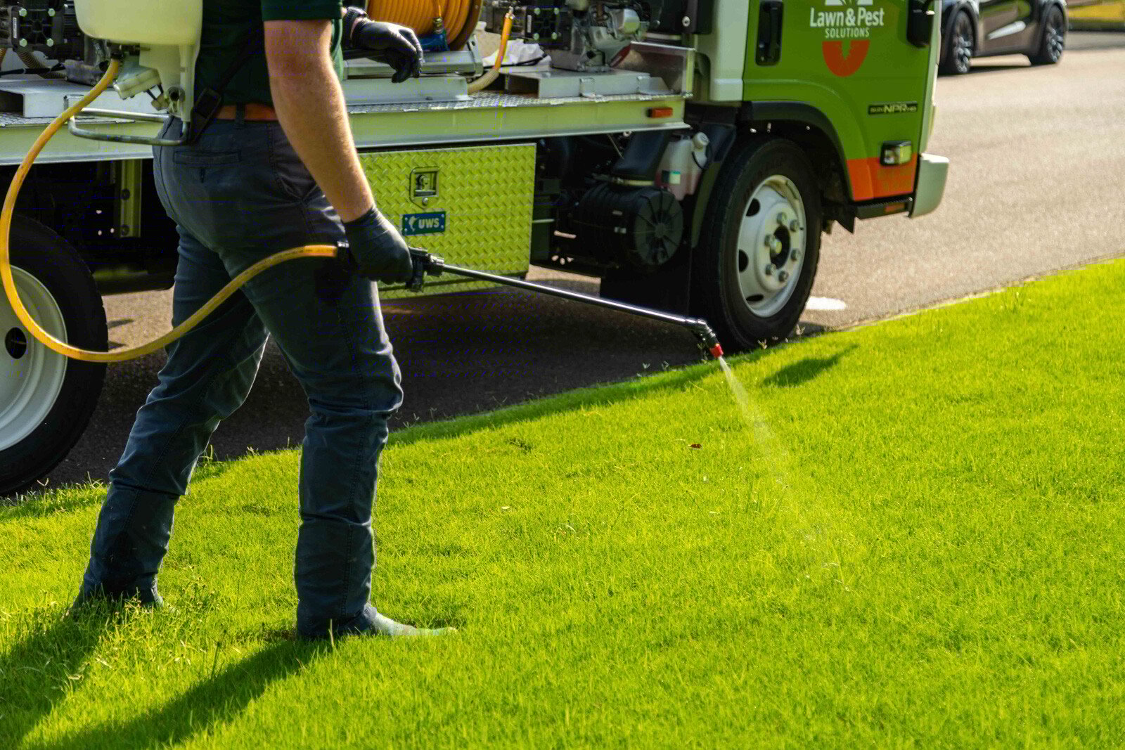 lawn care truck technician crew spot treatment weeds backpack  spray hose action 2