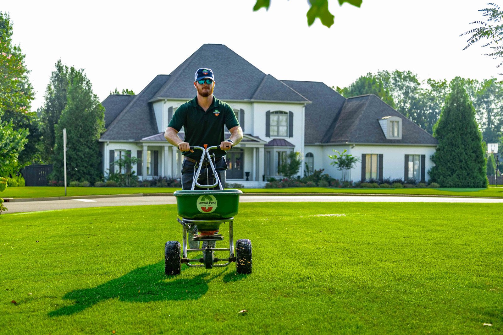 lawn care technician fertilizing lawn