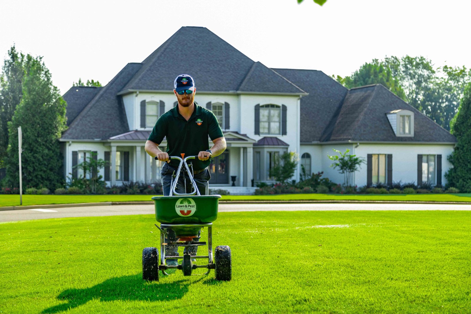 nice lawn care technician crew green grass spreader treatment granular fertilizer
