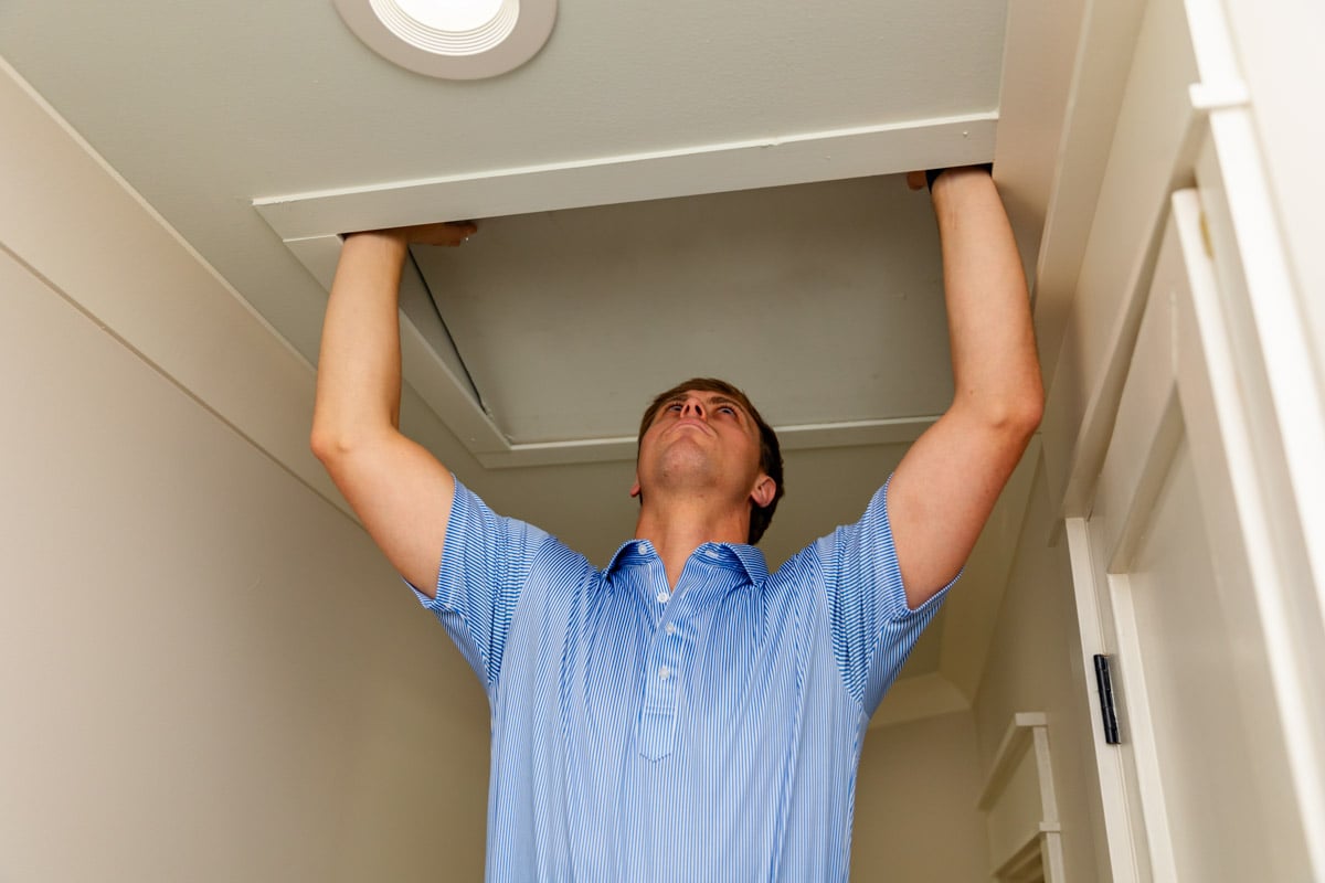 homeowner inspecting crawl space for pests