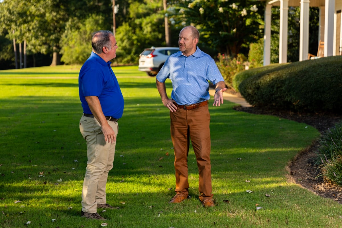 lawn care account manager and customer inspecting lawn 3