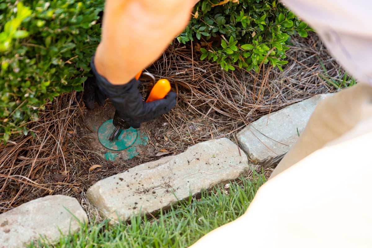 pest control technician drilling installing bait stations 13