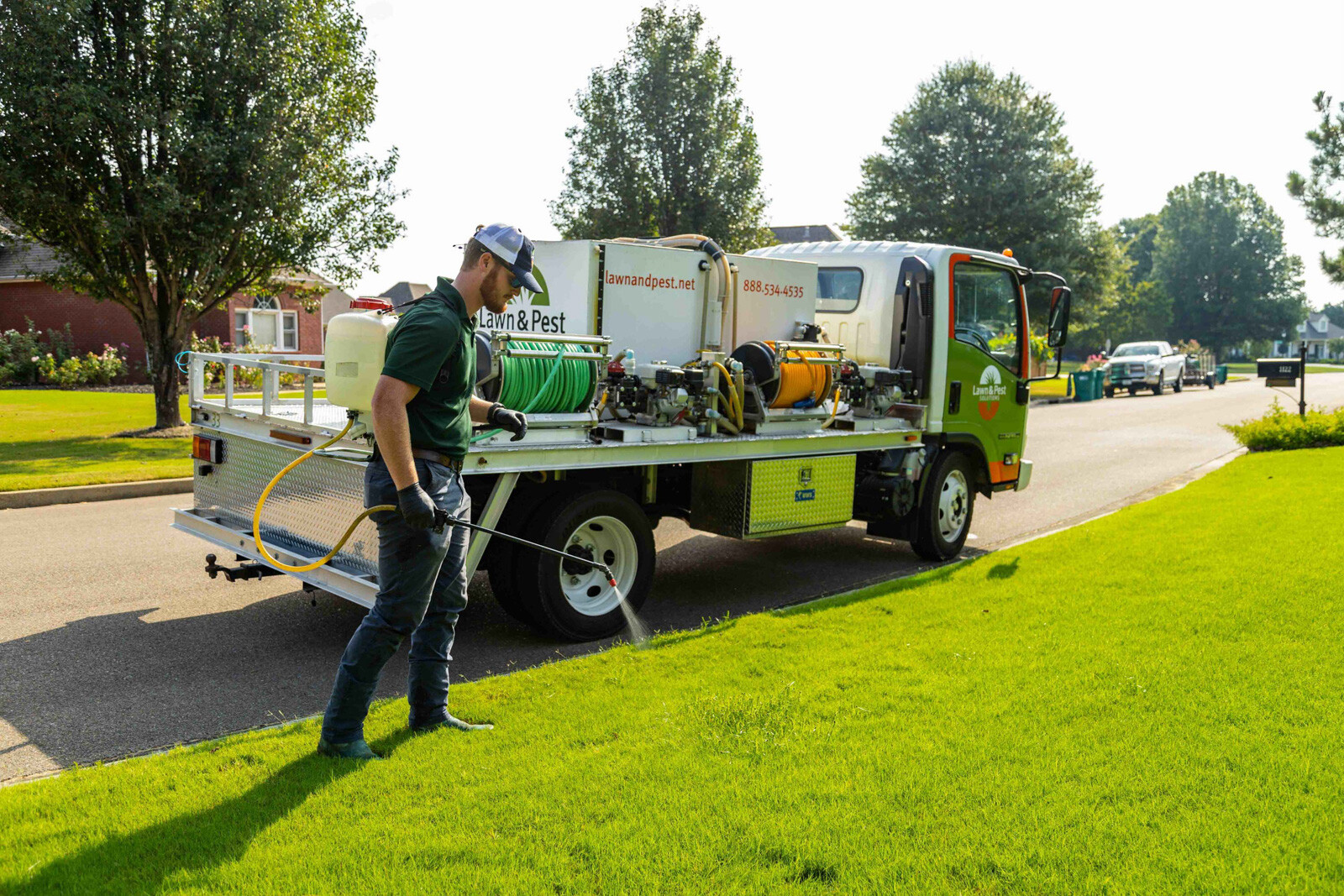 lawn care truck technician crew spot treatment weeds backpack spray hose action-1