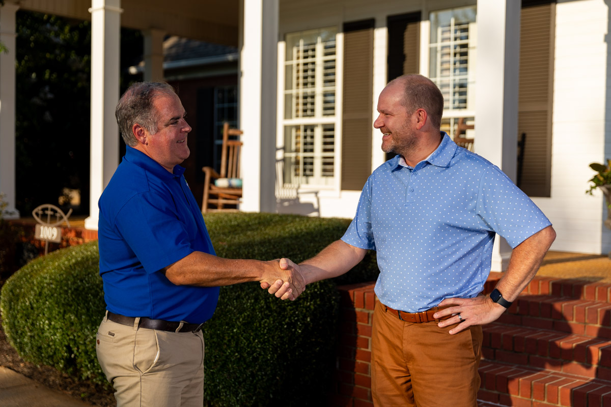 lawn care account manager and customer shaking hands meeting