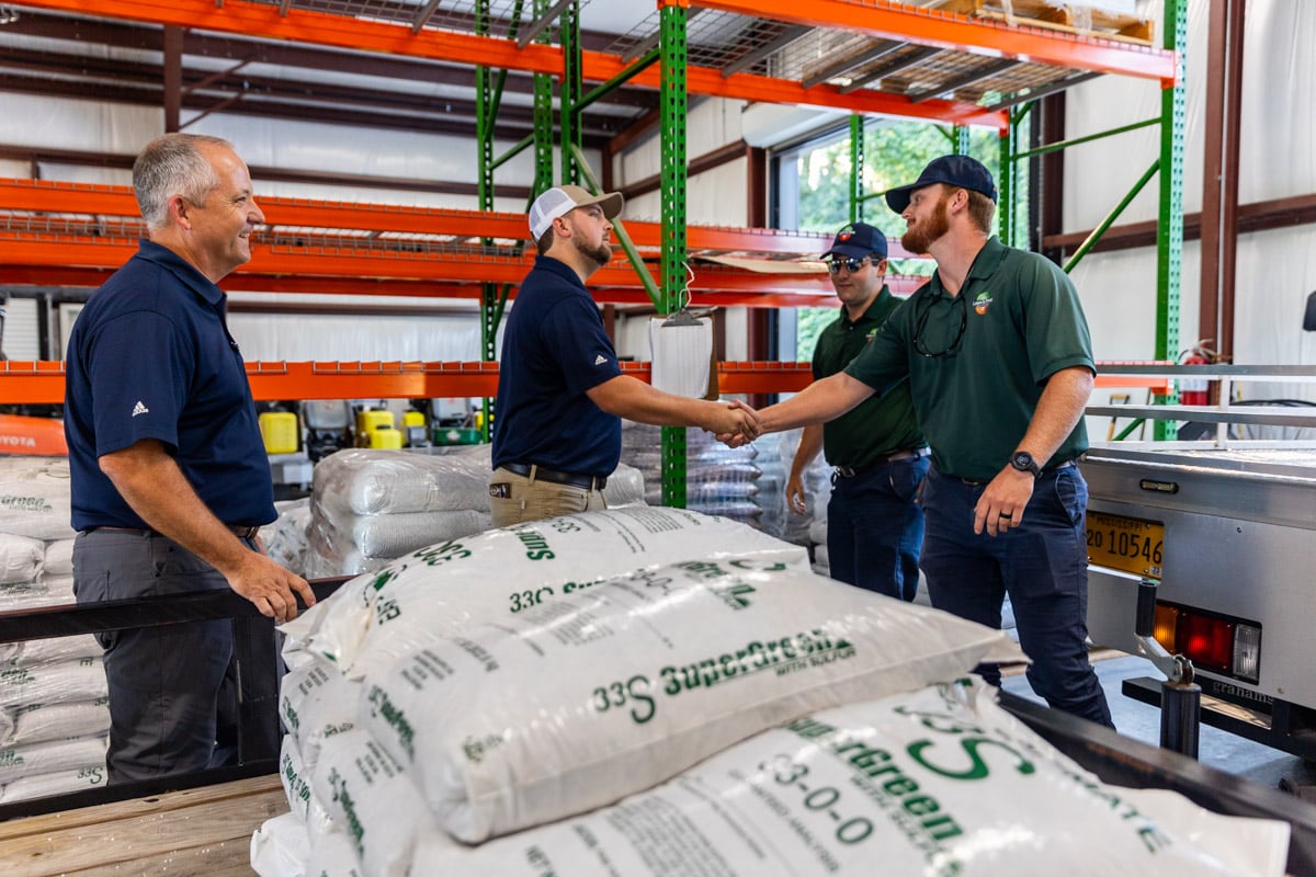 team members loading trailer with fertilizer shop garage 8